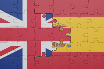puzzle with the colourful national flag of spain and flag of great britain.