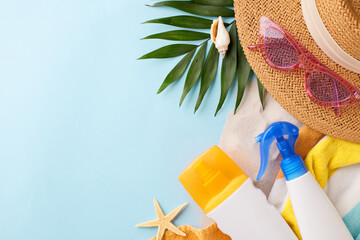 Beach essentials including a straw hat, sunglasses, and sunscreen, ideal for summer vacation...