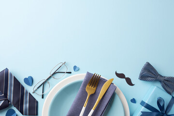 Elegant Father's Day table setting with blue accents, including glasses, mustache cutouts, and...