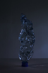 water bottle, rumpled, glows like crystal or ice