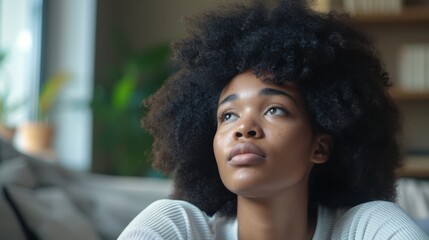 Fototapeta premium Female daydreaming, deep in thought while sitting on a sofa