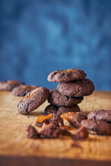 Pile of carob seeds on blue background