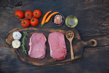 Top view raw beef meat steak ingredient uncooked cuisine on wooden board. Steak western cuisine...