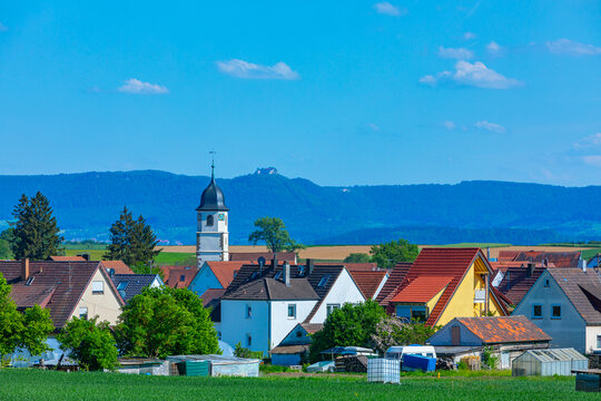church tower of wolfschlugen in germany and view to the castle neuffen