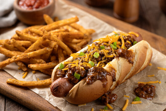 Chili hot dog with shredded cheese and green onions