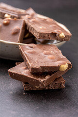 Chocolate cupcake with icing and chocolate bar in Dark lighting,Homemade delicious chocolate muffin on wooden background close-up