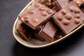 Chocolate cupcake with icing and chocolate bar in Dark lighting,Homemade delicious chocolate muffin on wooden background close-up
