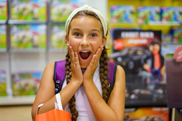 Cute girl surprised in a toy store