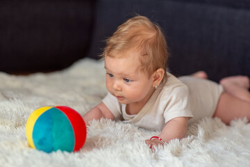 Happy Baby playing with ball.