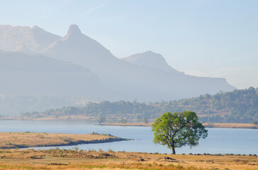 Beautiful moody, Misty, Hazy, Foggy landscape at Bhandardara, Maharashtra, India, Asia. Background. Backdrop. Wallpaper.