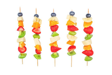 Fresh summer fruits on sticks isolated on white background, summer health concept