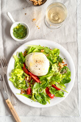 Italian salad: seome ingredients are salad, tomato slices, walnuts, mozzarella, olive oil, lentils...