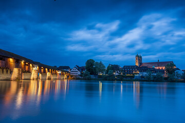 skyline of bad säckingen germany at night with reflection of the illuminated ancient wooden bridge...