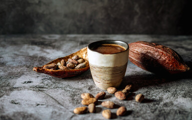 Natural craft cocoa drink, organic healthy chocolate drink with brown cocoa beans and dry cacao pod