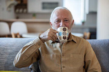 Mature man drinking tea at home. Senior man drinking fresh tea at home.