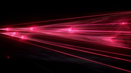 Abstract and artistic, this image captures red laser streaks speeding across a pitch-black background