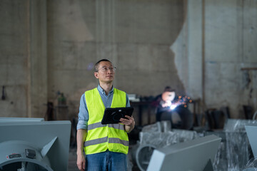 person working with tablet in workshop