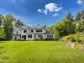 Spring growth and green energy -trees surrounding suburban home with bright green Spring growth....