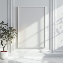 Minimalist interior with blank white frame and potted plant in bright natural light and shadows.