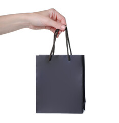 Brown gift bag in female hand on white background isolation