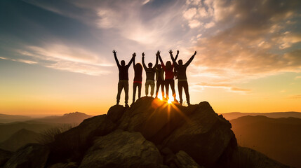 Silhouette of Diverse Team Celebrating Success on Hilltop at Sunset - Unity and Togetherness Concept