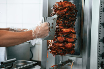 Chef preparing and making traditional Turkish Doner Kebab meat. Shawarma or gyros