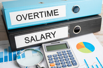 Overtime, Salary. Binder data finance report business with graph analysis in office.