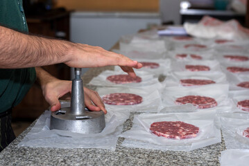 Fototapeta premium making homemade hamburgers with ground meat and chef making the medallions