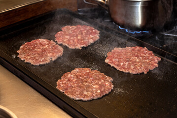 cooking, assembly and manufacturing of homemade hamburgers with ground meat and chef making the...