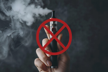 Hand hold electronic cigarette, vape in smoke and prohibition sign. Stop smoke. No Smoking Day. Nicotine addiction