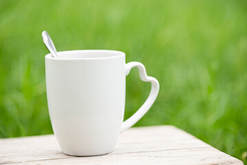 White mug on wooden table.