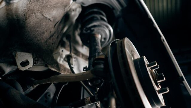 close-up at service station of an old rusty car shock absorber to be repaired