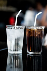 Glass of ice in clear glass cup and ice soft drink in table. Refreshing and healthy water on hot days