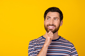 Portrait of toothy beaming guy with stylish stubble wear striped t-shirt look at promo empty space...