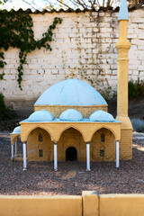 Close-up clay model of a mosque in a miniature park