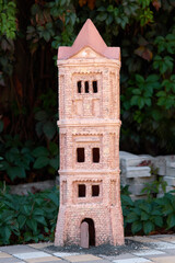 Close-up clay miniature figure of a fairy tower in the garden