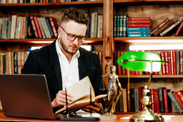 Fototapeta premium Concept of legal work, litigation. Justice and law concept. A lawyer works with a laptop in the court office.