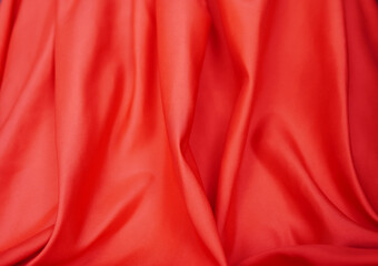 Red satin or silk is beautiful and luxurious. Background (blurred)