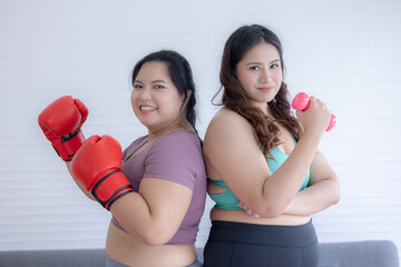 two woman exercising with dumbbells and boxing	