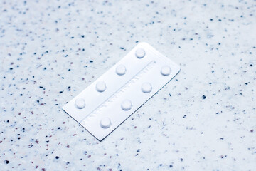 Electric blue blister pack of pills on counter top