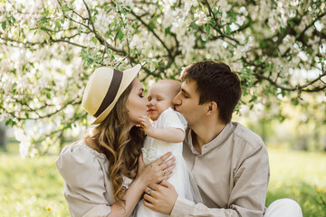 Beautiful mother and daughter in hat with father on picnic