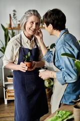 Two women engaged in conversation while in a kitchen.
