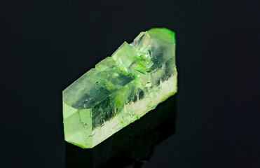 natural green crystal on a black background