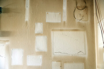  Eine vergilbte Wand in einer Raucherwohnung mit hellen Stellen von den Bildern