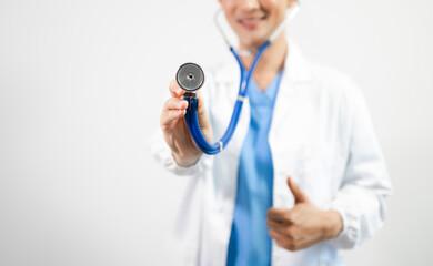 Man portrait of a doctor wearing a white coat and a stethoscope looking into the camera on a white...