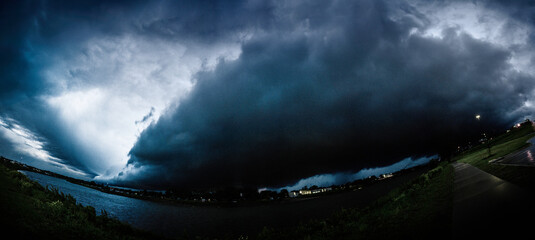 Ominous Massive Storm Clouds Looming over the Missouri River: A fisheye lens view of twilight...