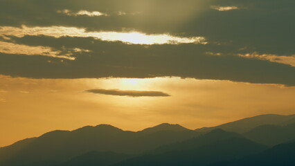 Sunrise Background Over The Mountain. Mountains Silhouette And Cloud. Real time.