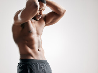 Black man, muscular and fitness with abs for workout, exercise or training on a white studio...