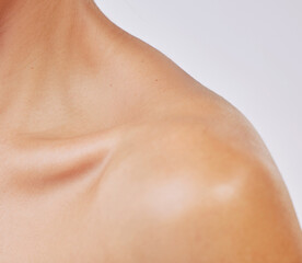 Person, skin and closeup of shoulder for skincare, wellness and clean glow with sunscreen, shine...