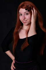 portrait photographs of a beautiful redhead woman on black background